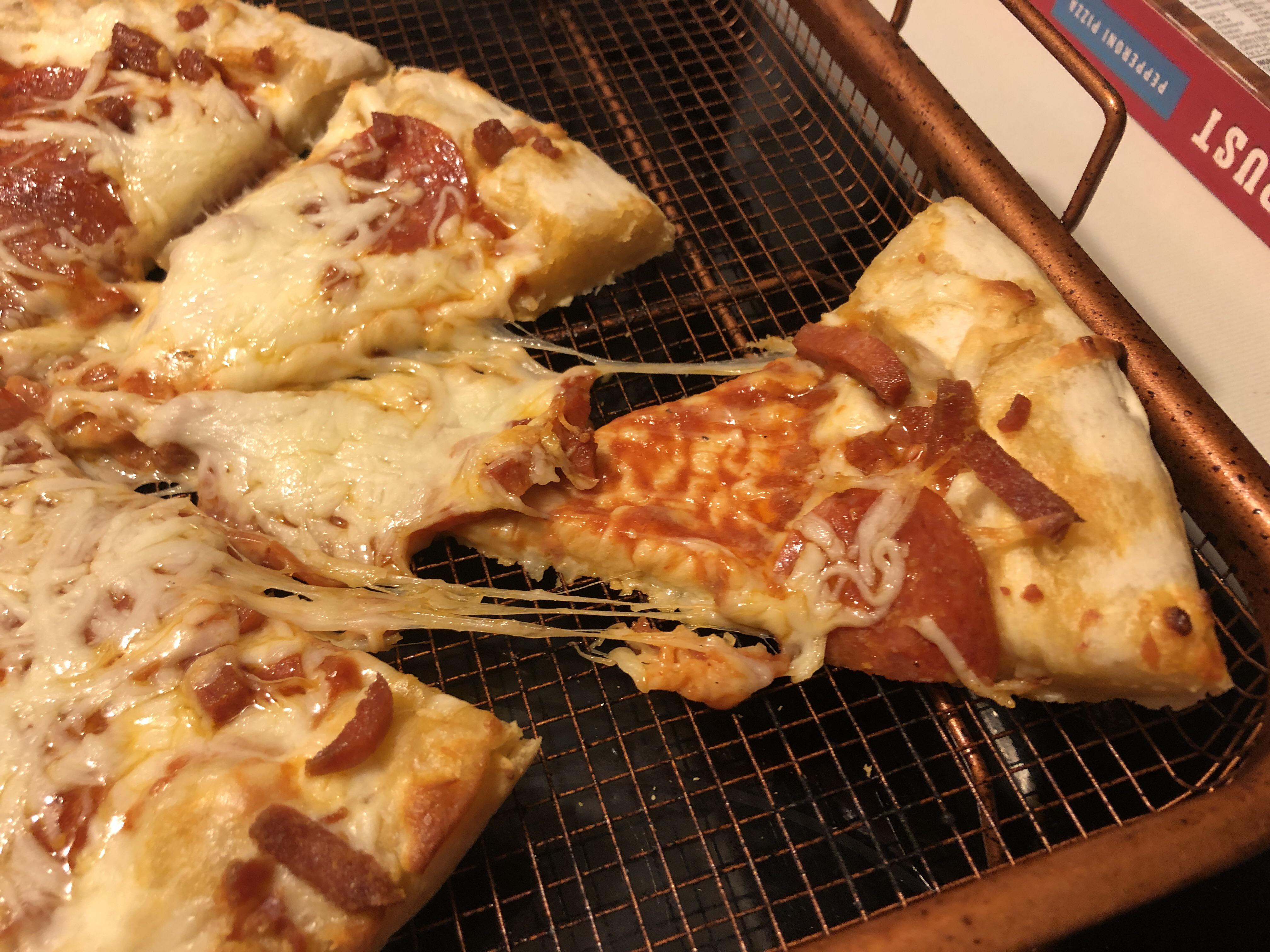 cheese falling off of a pizza